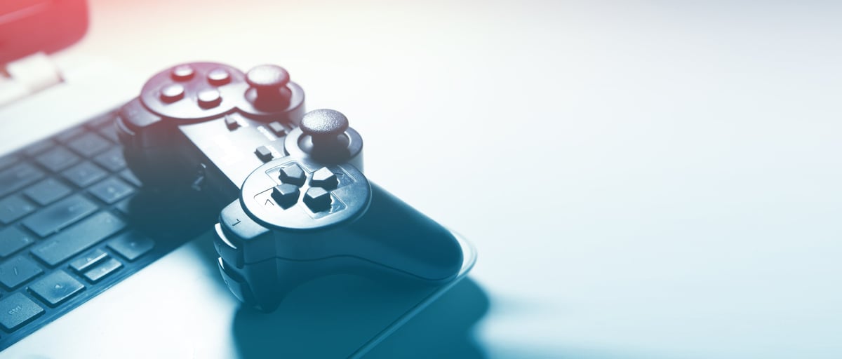 Gamepad and computer keyboard on a white background with focus on the joystick
